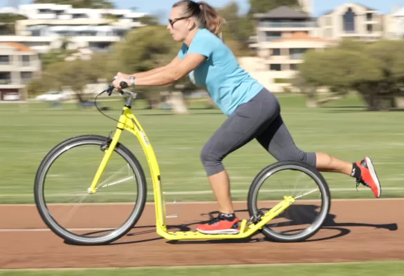 regina_striding woman riding footbike scooter recreation
